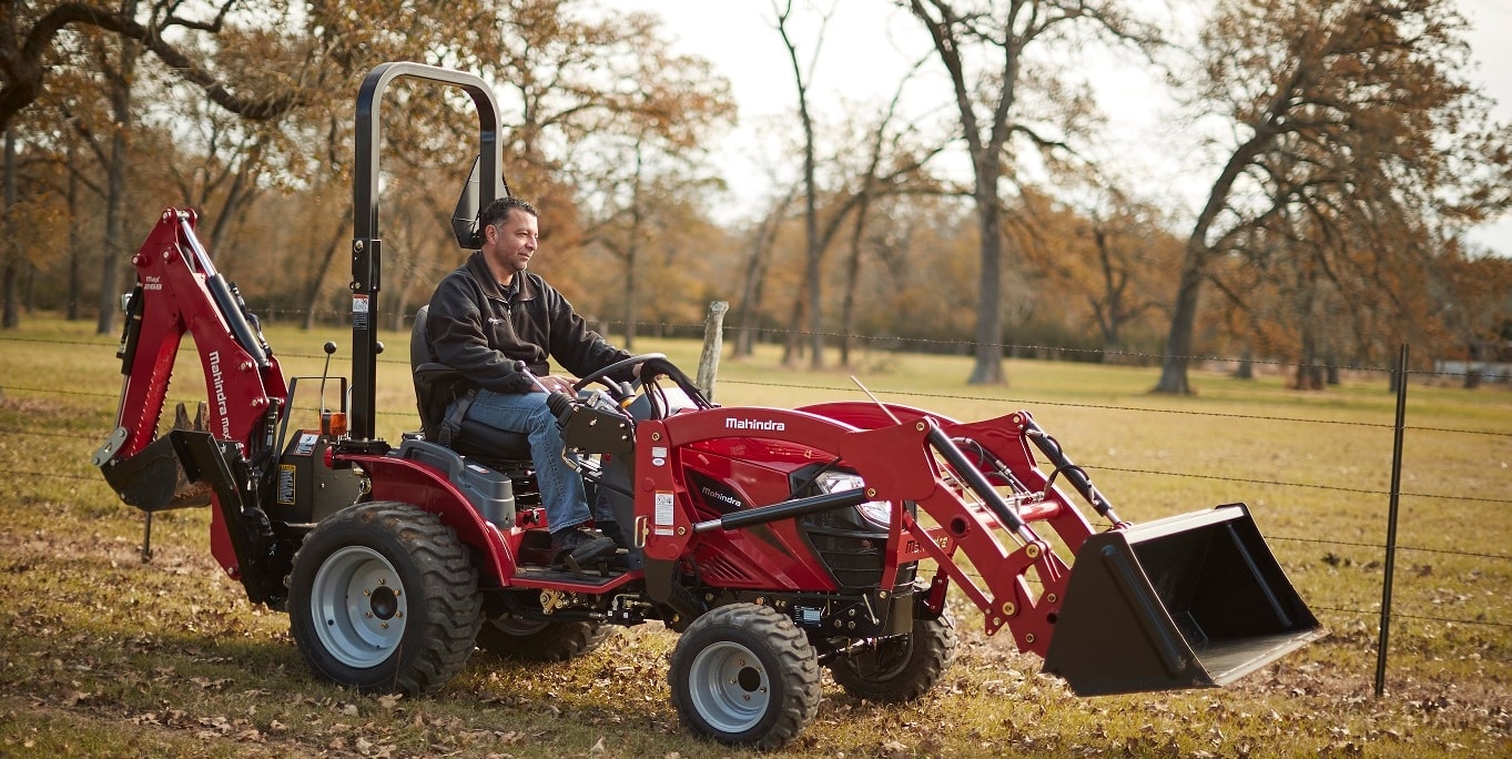 Mahindra tractor with a backhoe in an autumn field